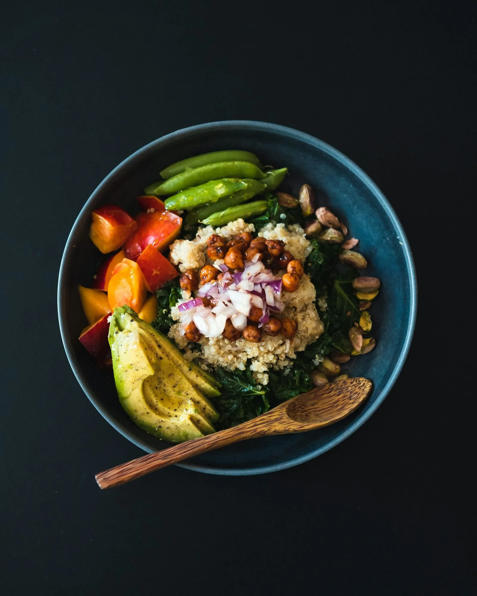A bowl of chickpeas, vegetables and avocado