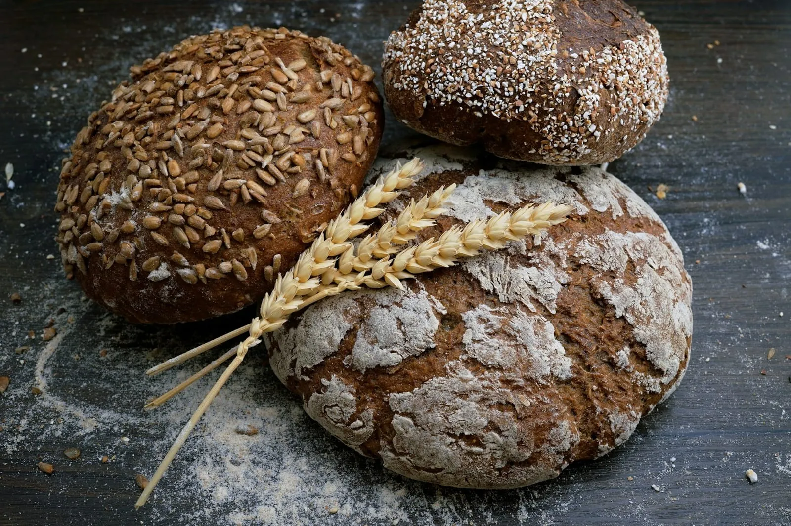 Rustic seeded loaves of bread with wheat